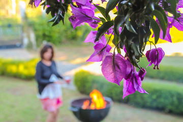 Violet leaves close-up with barbequeu in the background