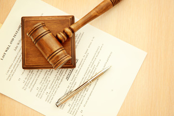 Court gavel and documents on table, top view