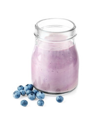 Mason jar with tasty smoothie and blueberries on light background