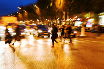 zoom picture people crossing a street at night