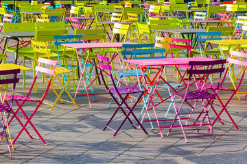 square filled with colorful tables and chairs
