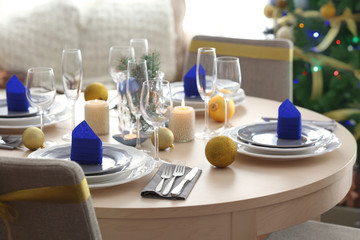 Table served for Christmas dinner in living room, close up view