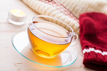 A Cup Of Tea With Winter Clothing And A Tealight