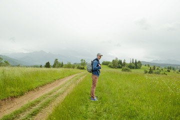 Traveler Man with backpack mountaineering