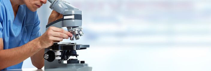 Doctor man with microscope.