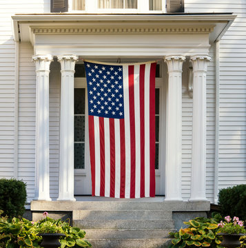 American flag displayed on the door of New England home