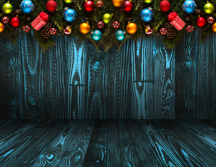 2017 Happy New Year seasonal background with real wood green pine, colorful Christmas baubles, gift boxe and other seasonal stuff over an old wooden aged background