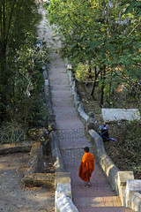 monk walking down long stairs