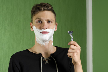 Confused teen with razor