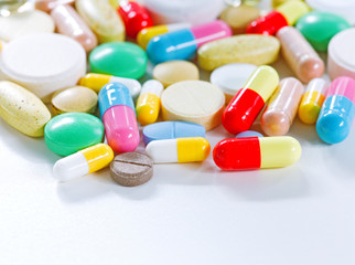 Vitamins, omega 3, cod-liver oil, dietary supplement and tablets an embankment on a light background close up, the top view