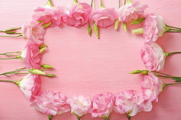 Fresh flowers frame on pink background