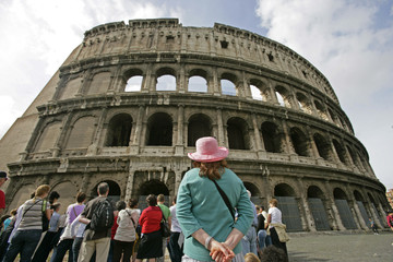 woman looking up at colosseum