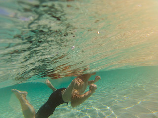 man swimming in clear caribbean sea