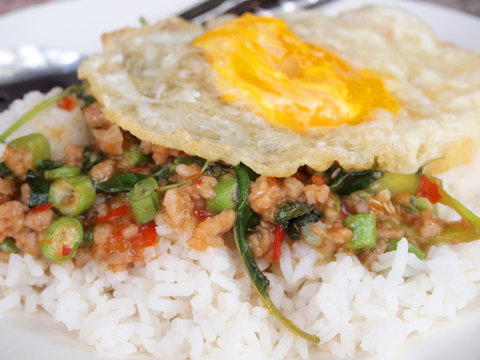 Close up Rice topped with stir fried pork and basil