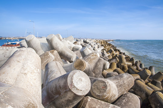 Breakwater in Portugal seashore formed by concrete blocks
