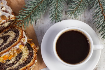 Poppy seeds cake, cup of coffee and spruce branches, dessert for Christmas