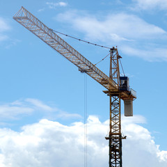 Industrial landscape with cranes on the blue sky