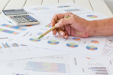 Hand pointing at business chart