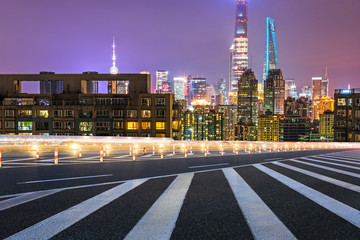 Obraz premium empty asphalt road through modern city in China.