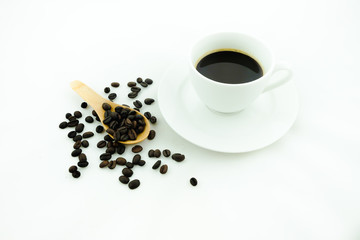 A cup of coffee and coffee beans. White background.