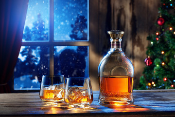 close up view  of two glasses with whiskey on color back