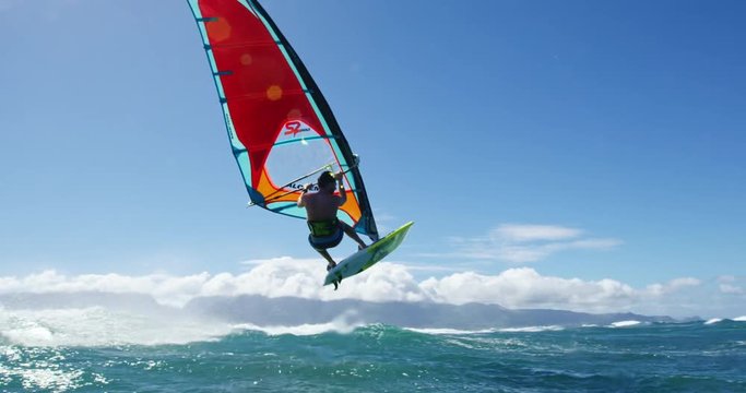 Windsurfer gets big air jumping off wave, Extreme sport