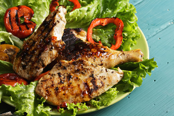 Grilled chicken breasts and leg closeup