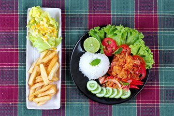  Home made,Jasmine rice with spicy fried chicken salad (Khao Yum Kai Zap in Thai) topped sliced cucumber,tomato,halved lemon and lettuce served with mixed vegetables salad and french fires.