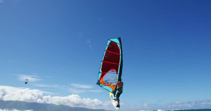 Windsurfer gets big air jumping off wave, Extreme sport