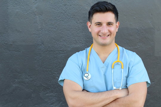 Stock image of medical intern standing with arms crossed over gray background
