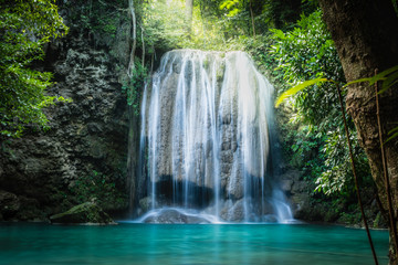 Fototapeta na wymiar Erawan waterfall, the beautiful waterfall in deep forest at Erawan National Park - A beautiful waterfall on the River Kwai. Kanchanaburi, Thailand