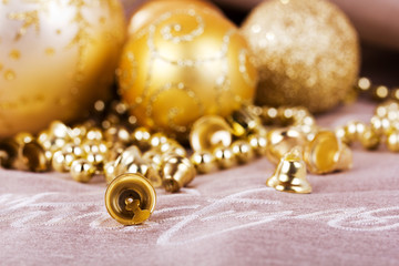 Festive gold Christmas decorations on fabric background
