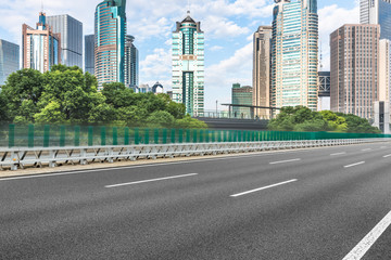 empty asphalt road through modern city in China.