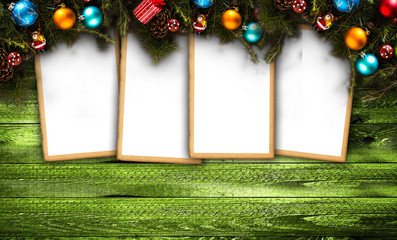 Merry Christmas Frame with real wood green pine, colorful baubles, gift boxe and other seasonal stuff over an old wooden aged background