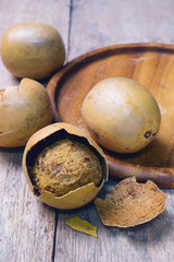 luo han guo (monk fruit, fructus momordicae, momordica grosvenori, siraitia grosvenorii) on wooden background.