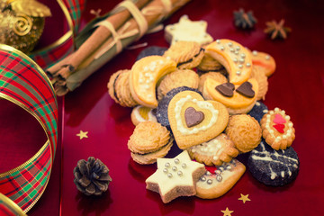 Christmas cookies with festive decoration on red background