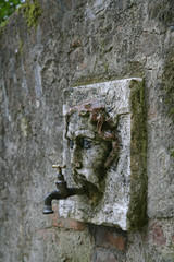 stone face water spogot