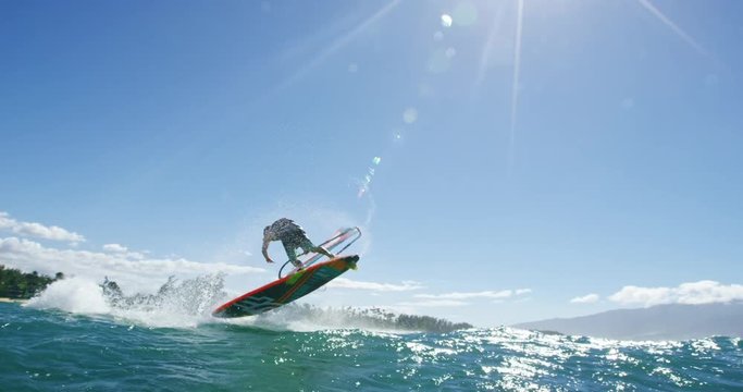 Windsurfer gets big air jumping off wave, Extreme sport