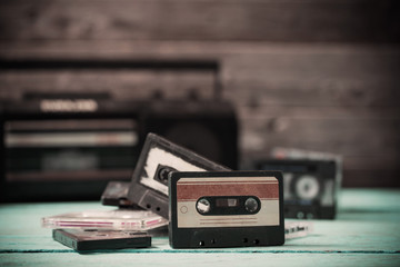 old cassette tape and player on the wood background