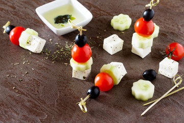 Appetizer canape. Greek salad with fresh vegetables, feta cheese