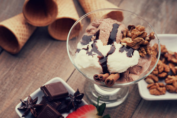 Ice cream sundae, waffle cone, walnuts and strawberry 