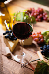 Wine glass, grapes and cheese 