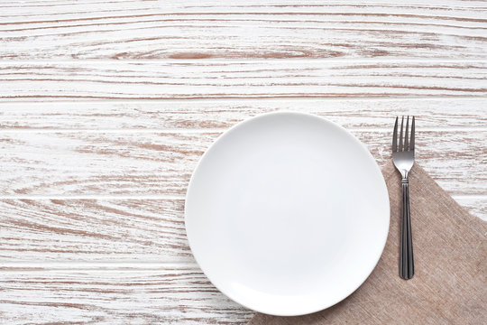 Empty Plate Napkin Fork Silverware White Wooden Table Background