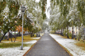 City alley with the first snow - blurred image