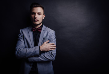 Confident man looking forward on dark background