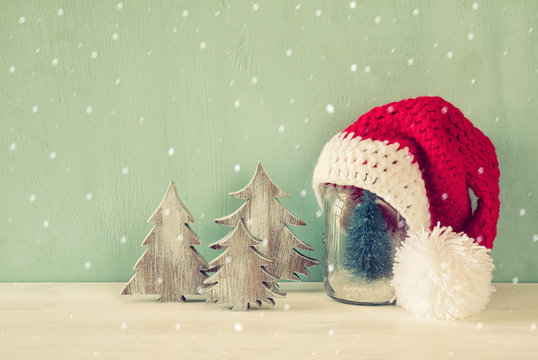 Image of christmas trees next to santa hat.