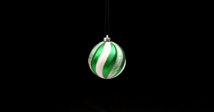 Spinning green christmas striped ball