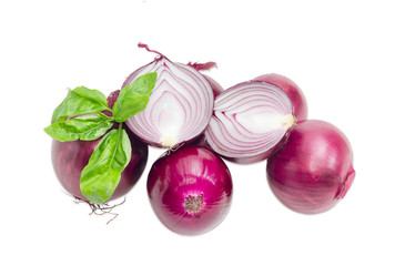Pile of red onion and twig of basil