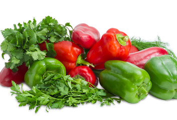 Several green and red bell peppers among the greens