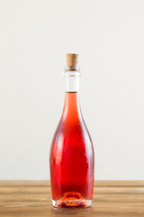 Bottle on table with rose wine